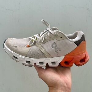 On Running Cream and Orange Athletic Shoes